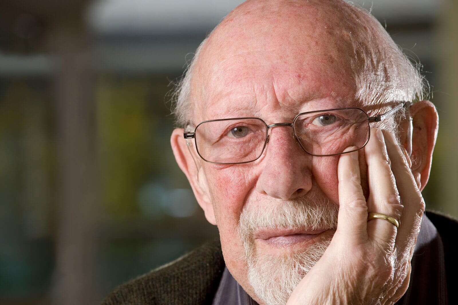 Elderly man with his chin in his hands