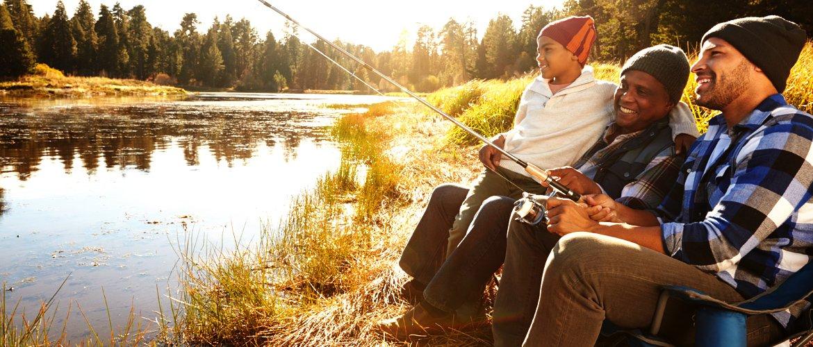 A grandfather fishing with his son and grandson