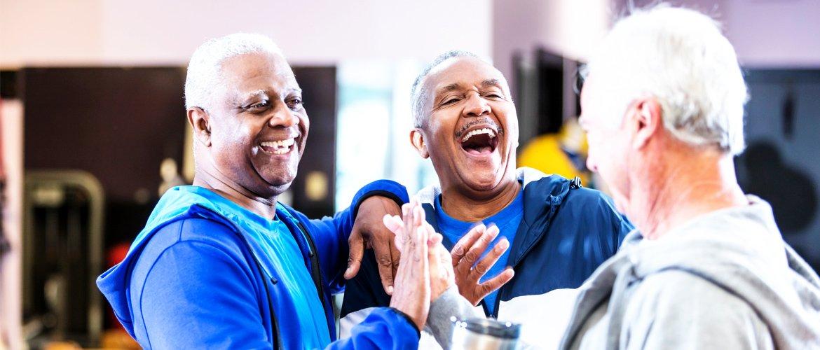 3 old friends joking at the gym