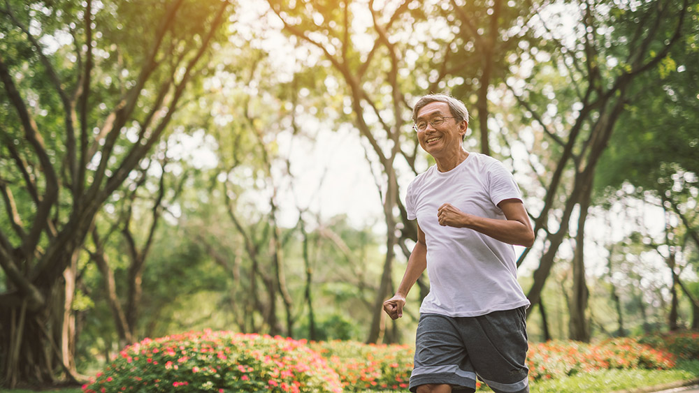 Senior mature man jogging In Park